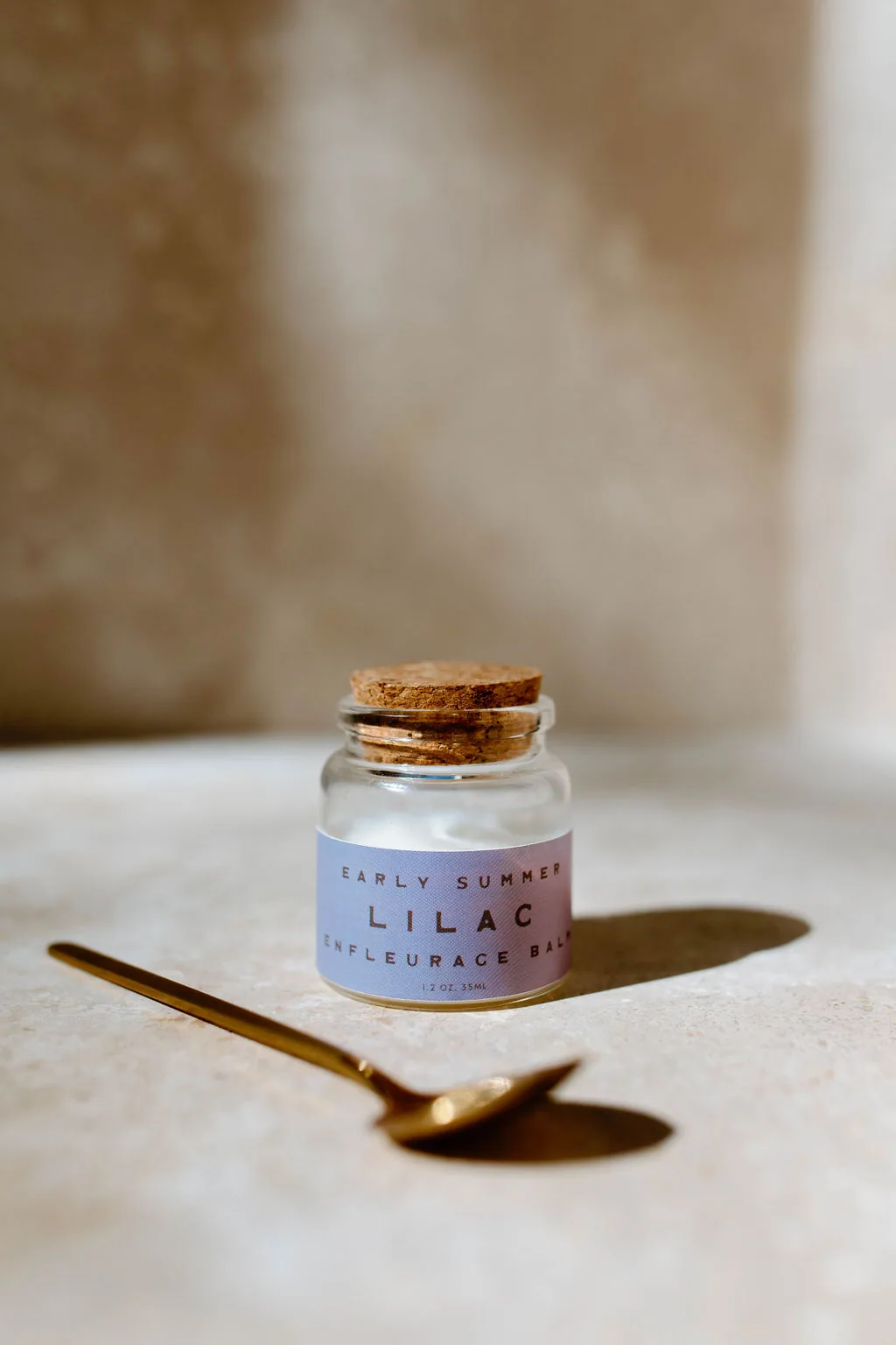 Early Summer Lilac enfleurage balm in a corked glass jar